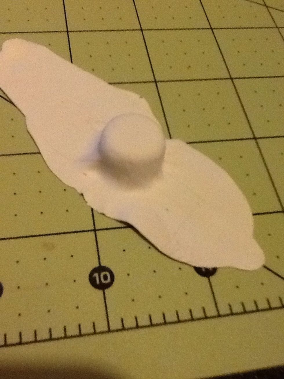 After rolling it out really thin without tearing, cover your cake layers. Then under the cake make a small thin layer to cover the cake layering.