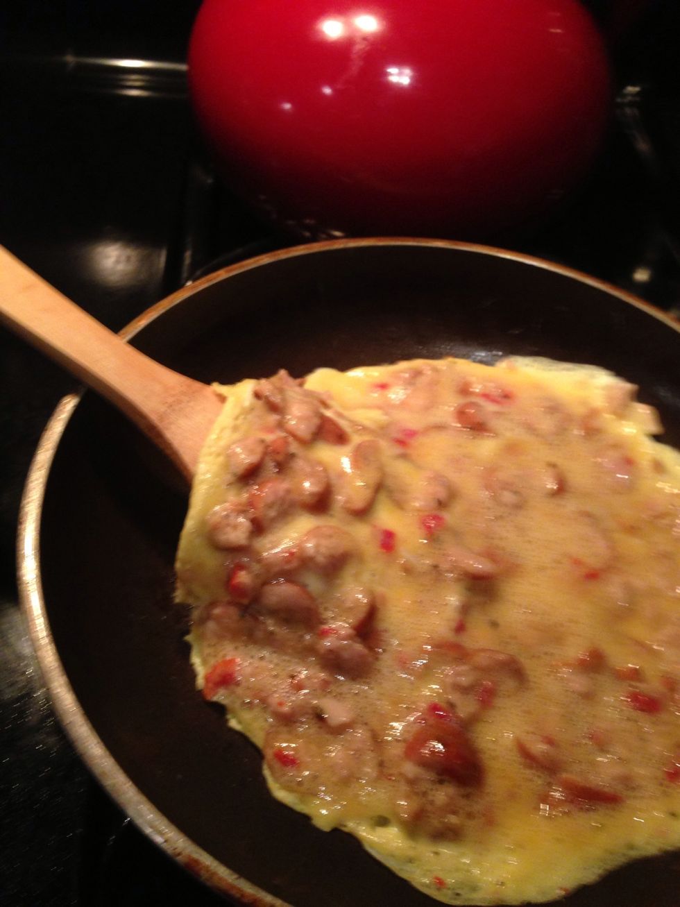 After roughly 5 minutes, carefully slide the spatula under the omelette to loosen and separate it from the pan