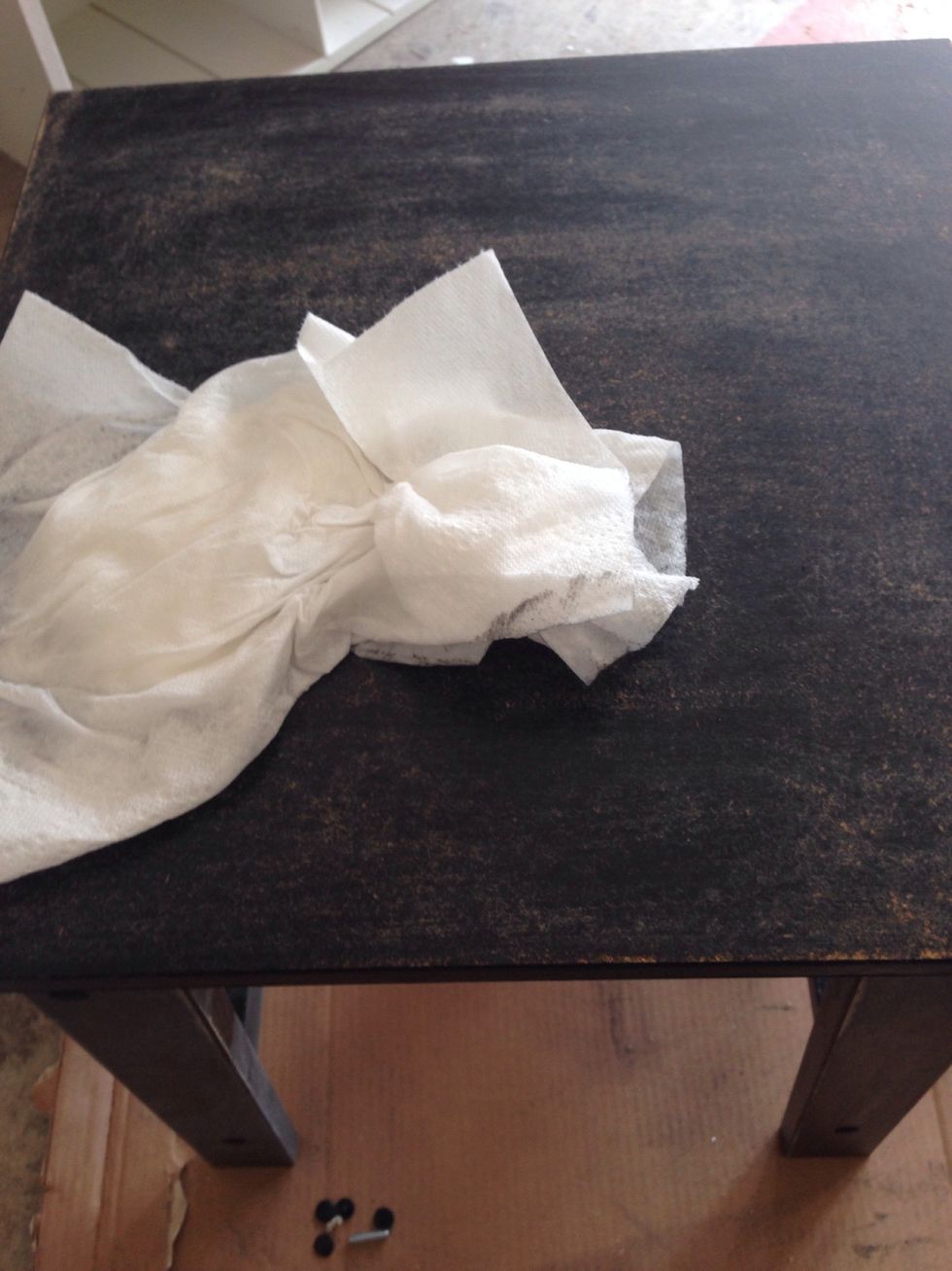 After sanding it, wipe the table down with a damp cloth.