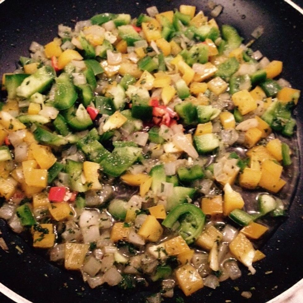 After saut\u00e9ing the herbs and onion for few minutes, add the chopped bell pepper, I used half yellow and half green, totally up to you