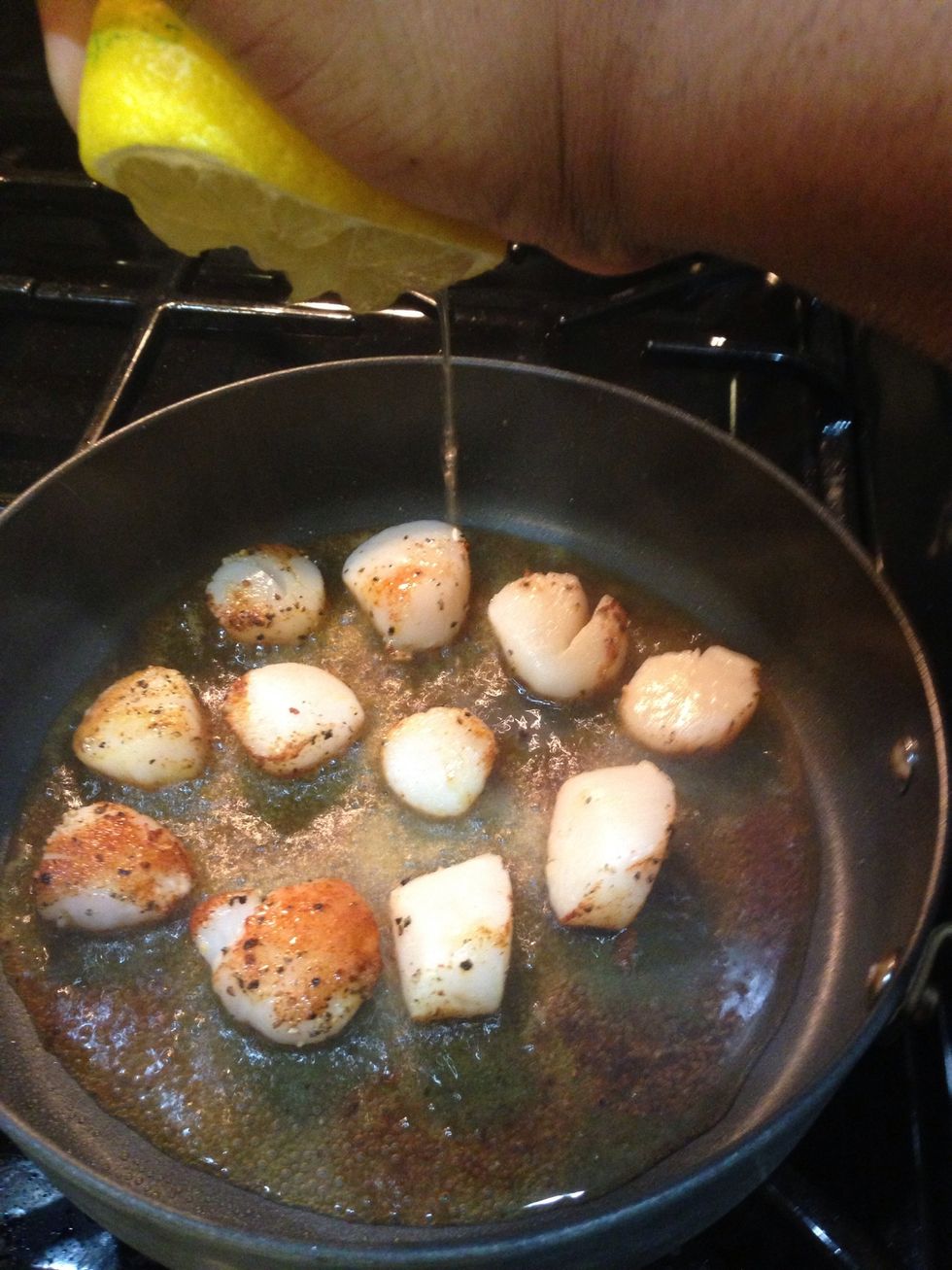 After scallop edges caramelize add the juice of half a lemon.  Increase heat to high. Flip scallops over, with tongs, for one minute and remove from skillet.