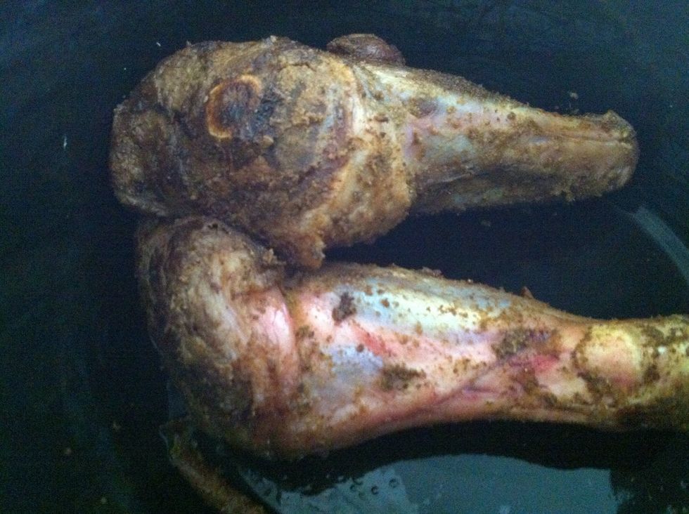 After sealing the lamb shanks remove them and place in the slow cooker too.
