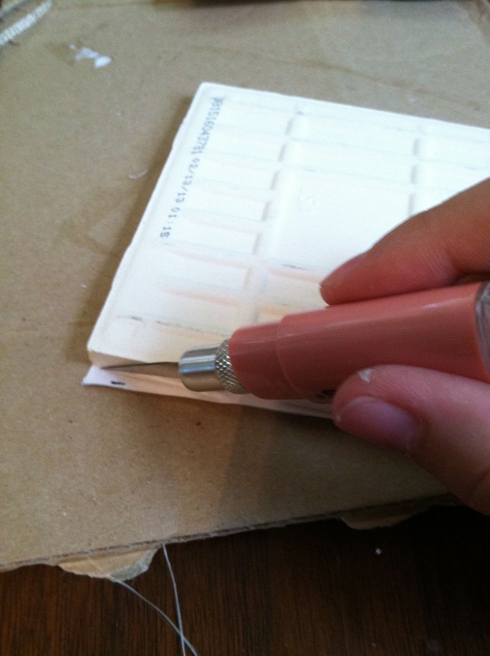 After smoothing out air bubbles (use another tile, a book, credit card, etc; always smoothing in one direction) flip over the tile and use the exacto knife to cut the paper down to fit the tile.