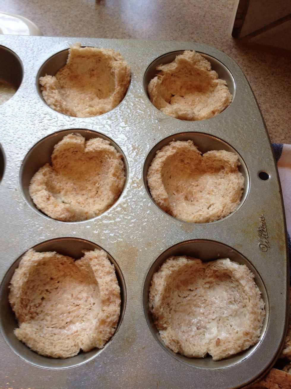 After spraying your muffin tray with Pam, squish the bread into the tins so they form little buckets