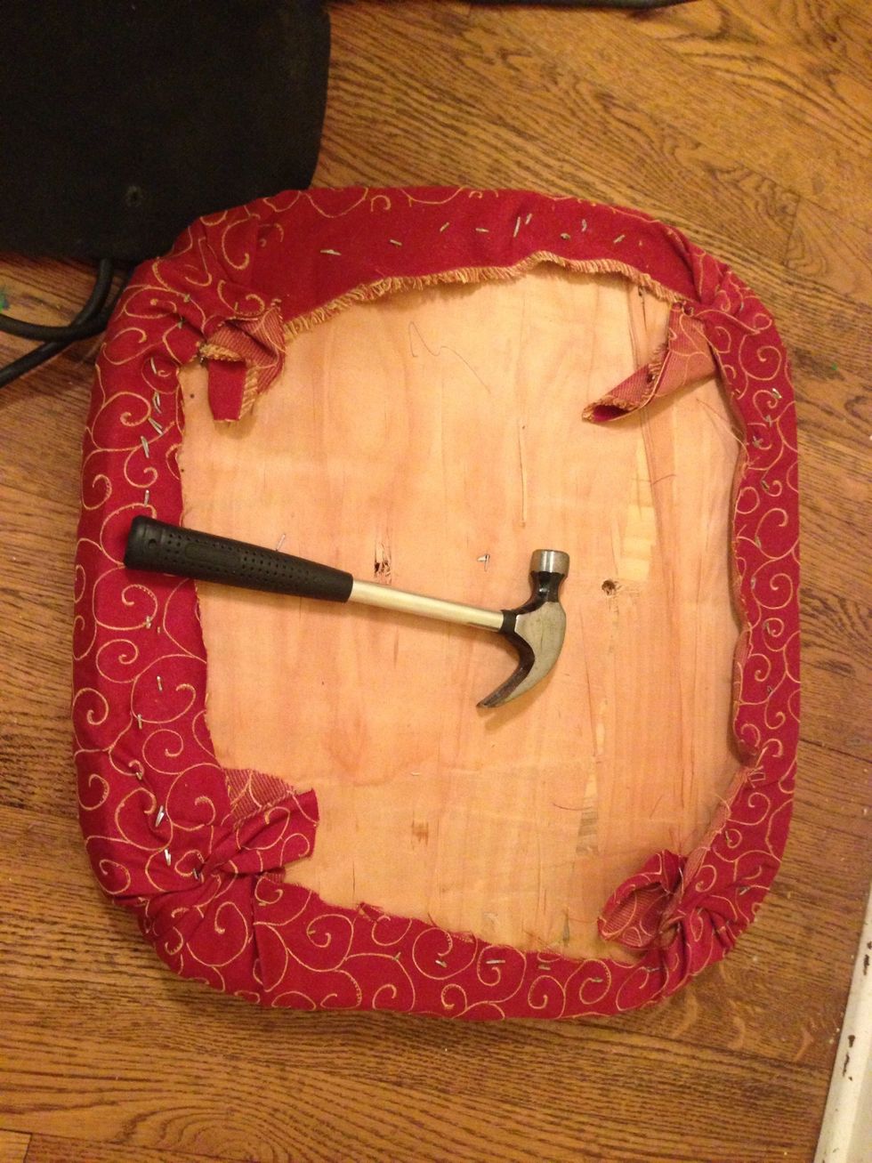 After stapling all sides and corners, pound down any raised staples.