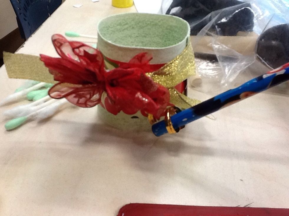 After,stick a wire under the fake flower and use the qilling tool to twist it.