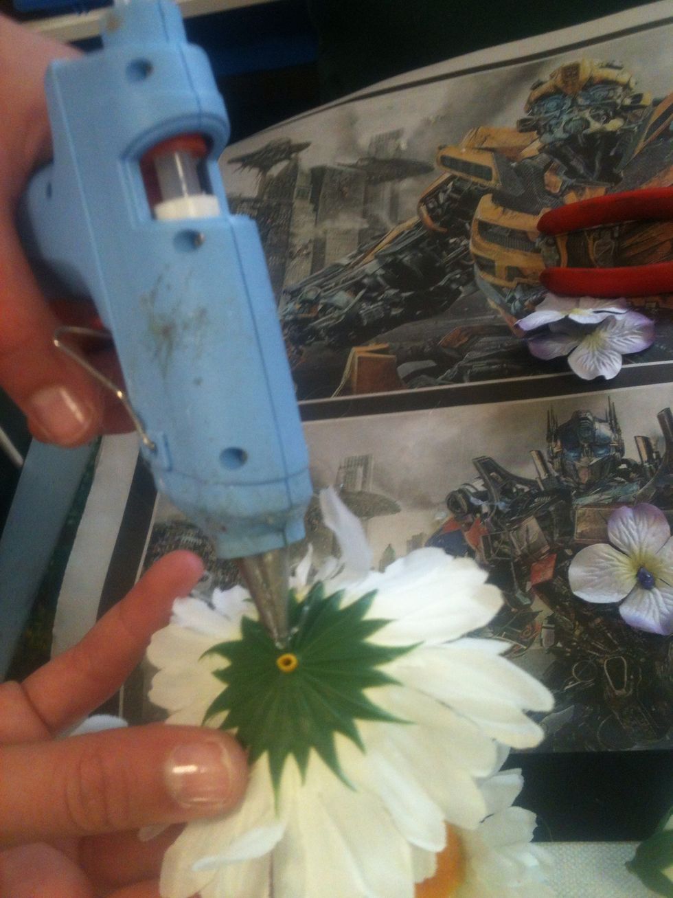 After sticking the flowers on with the hot glue gun wait until glue dries.