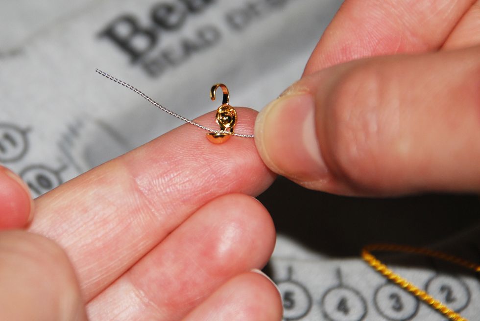 After stringing on all your beads, string on your 2nd clamshell end-cap - this time with the hook facing out. Note: do not close the clamshell yet.