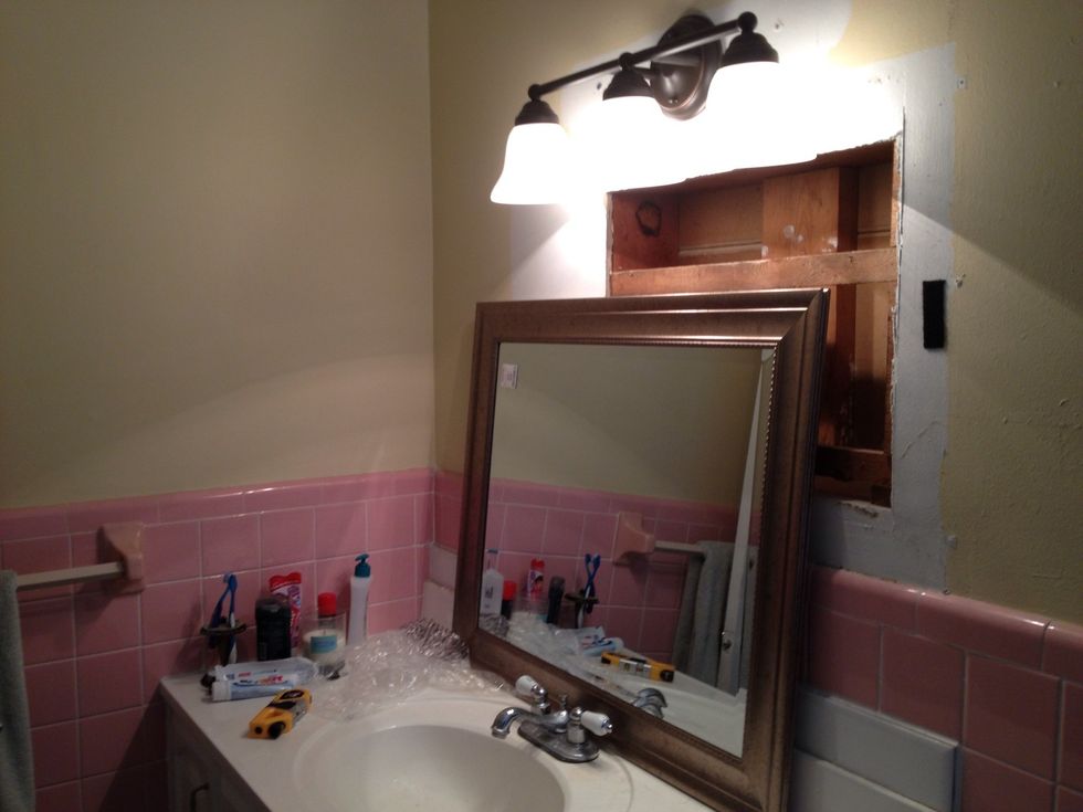 After taking down the old mirror, to put up the new mirror, I found this big old cut out.  This caused problems, because I couldn't center the mirror where I wanted, because the gap would be visible.