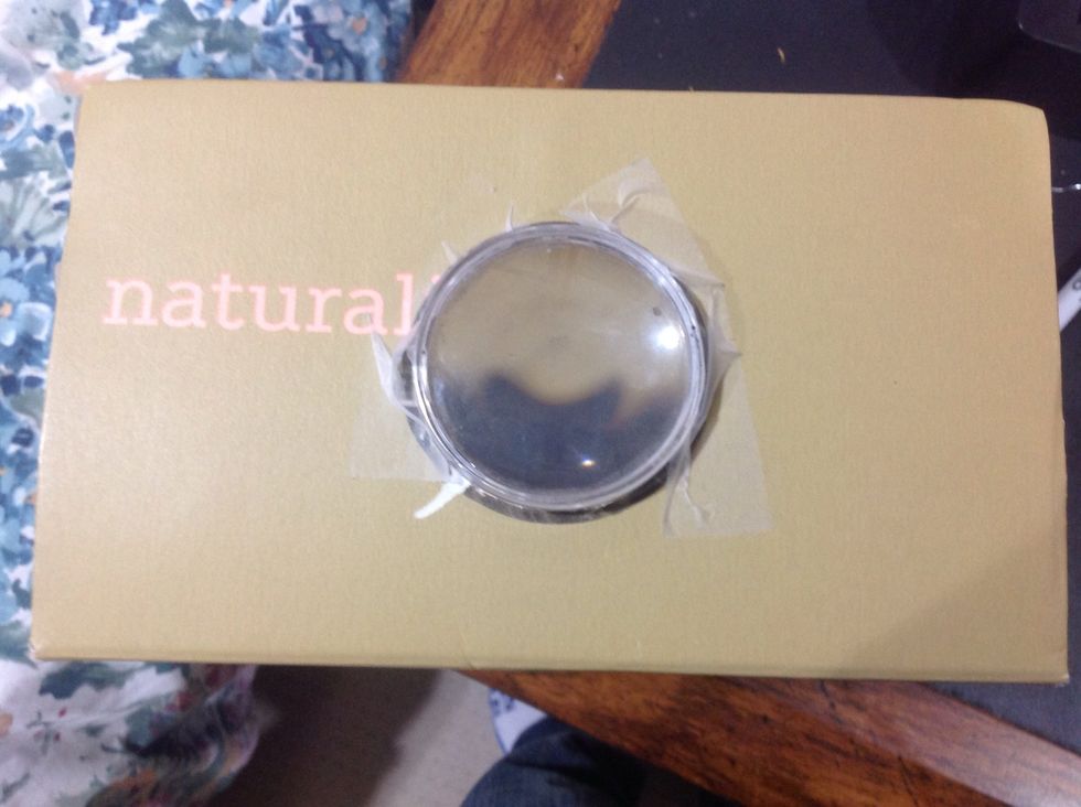 After, tape the lens to the inside of the hole.