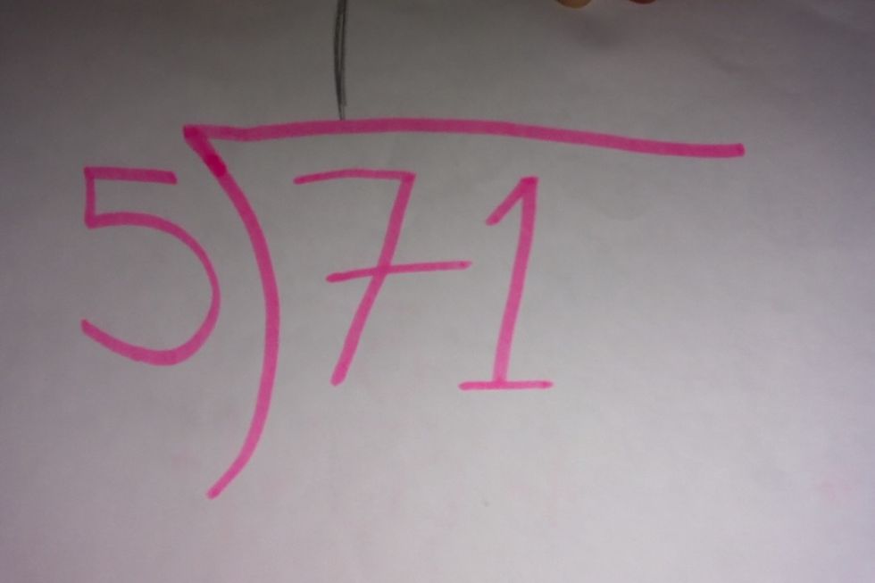 After that, add a one above the 7 because 7 only goes into 5 once.