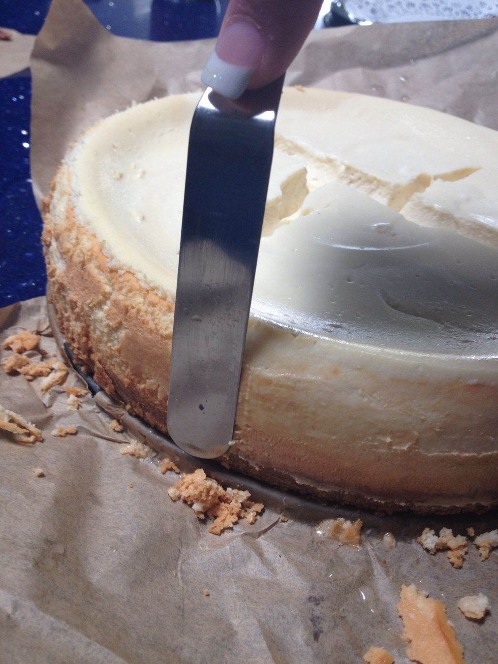 After that, continue dipping the icing spreader in the water and smoothing along the sides of the cake. See the before on the left and the after on the right