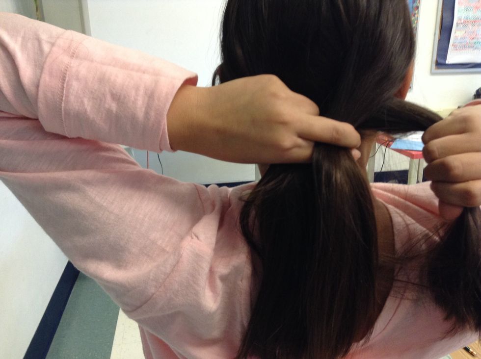 After that, Cross the right section of hair over the middle section.