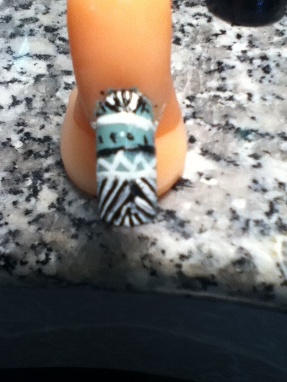 After that get your black and white nail polish and make lines on the nail.