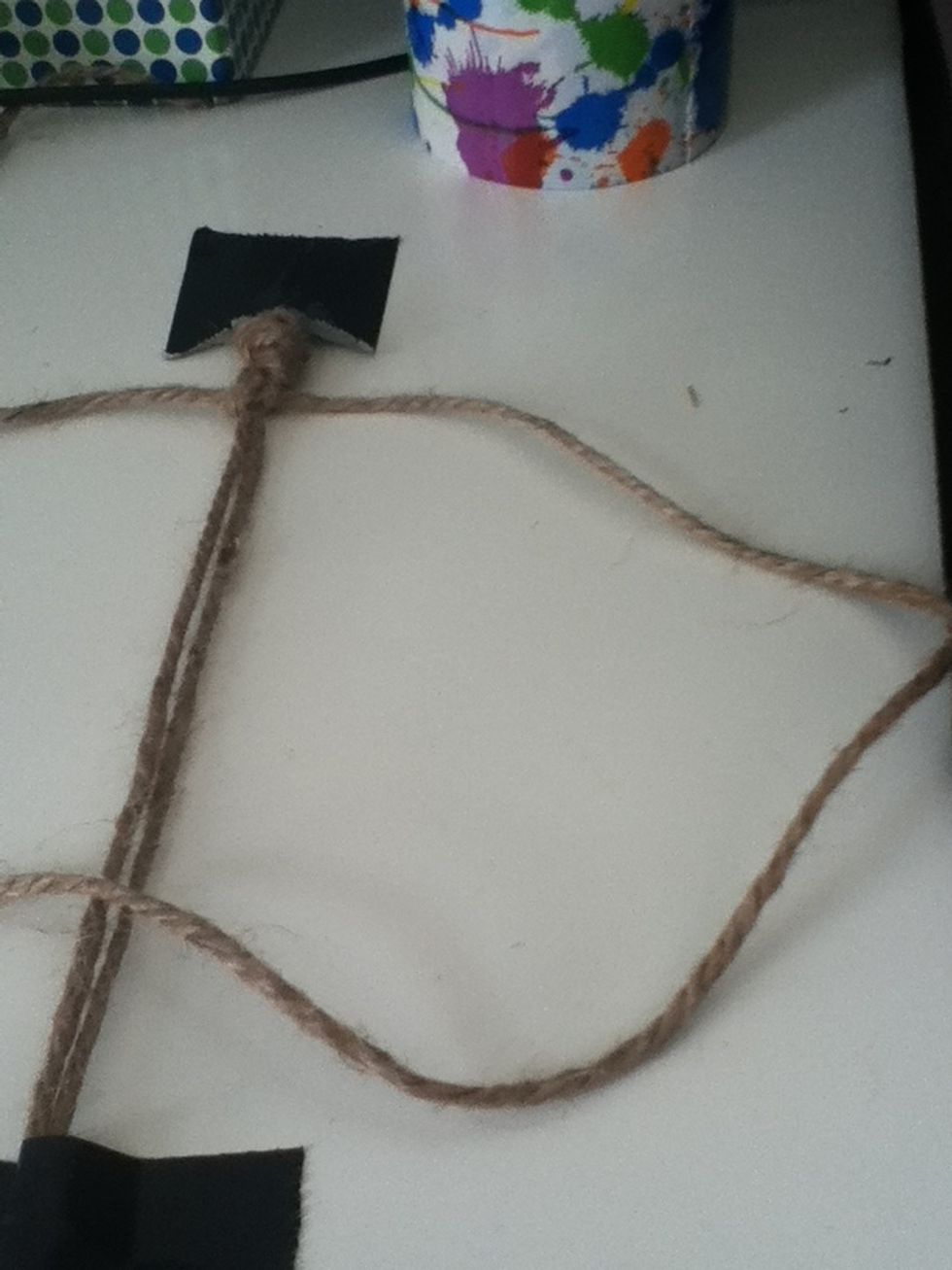 After that knot take the right string and put it over the middle. Take the left string and put it under the middle to make your knot just like you did before.