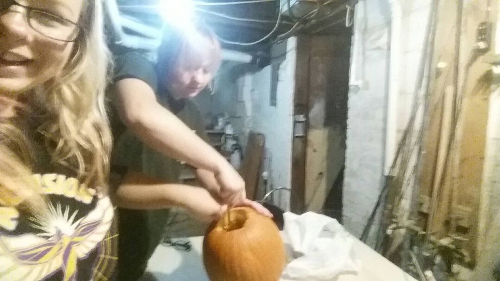 After that start getting all the seeds and pumpkin guts out with your hands or with another object.