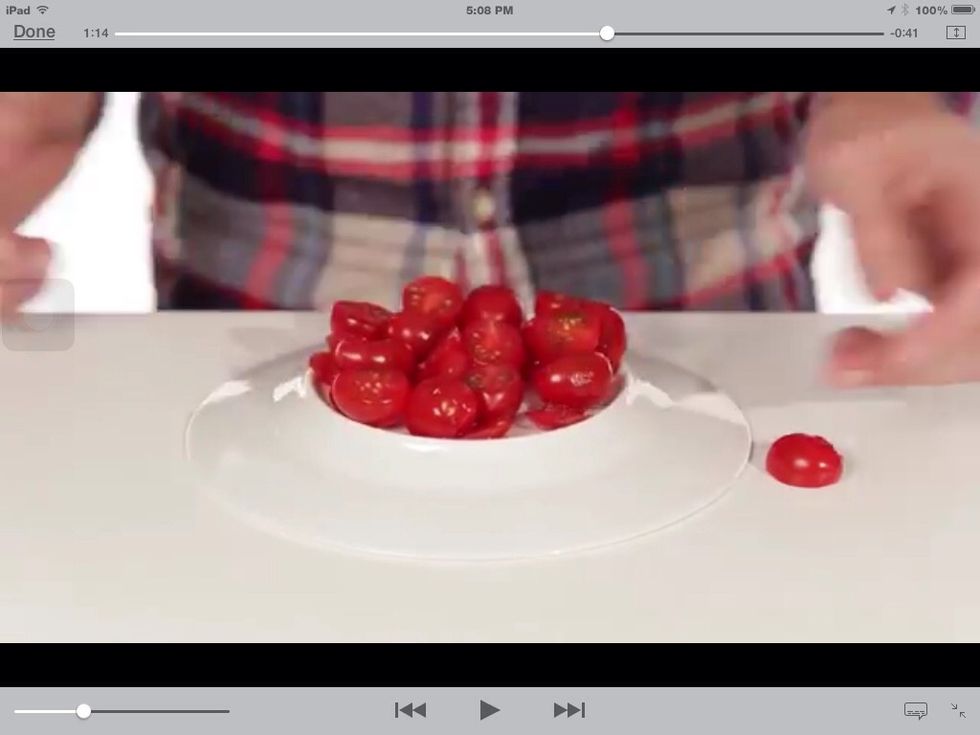 After that, take off the plate and reveal that all your tomatoes have been cut in half. At the same time!