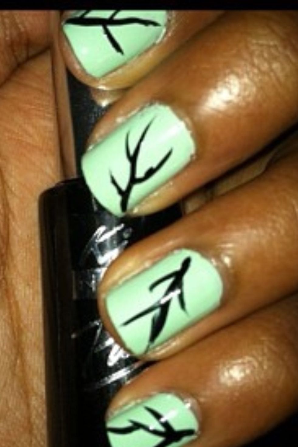 After that, use a black nail art striper to make the vines/branches.