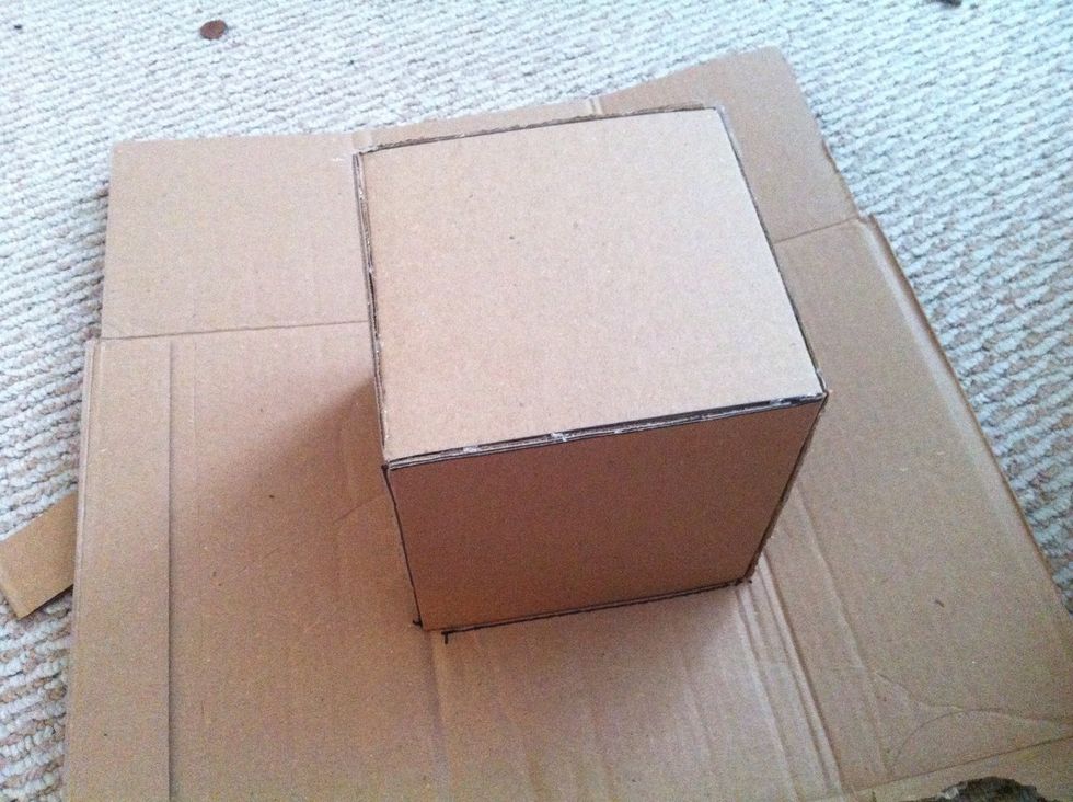 After that, we have to make a lid for the box. Put the box we just made on the cardboard, and mark the size for the lid.