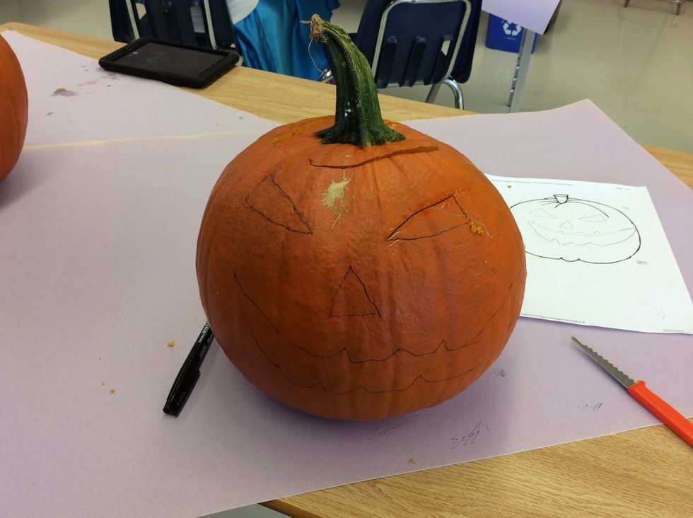 After that you draw the face on the pumpkin as scary as possible