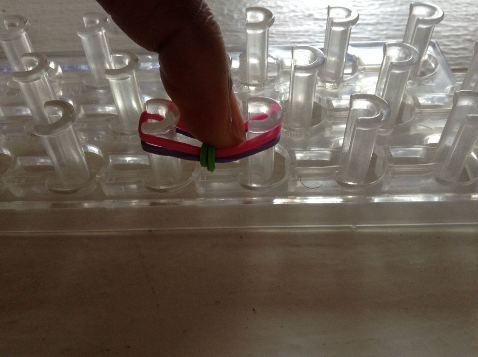 After that, you push down the two rubber-bands.