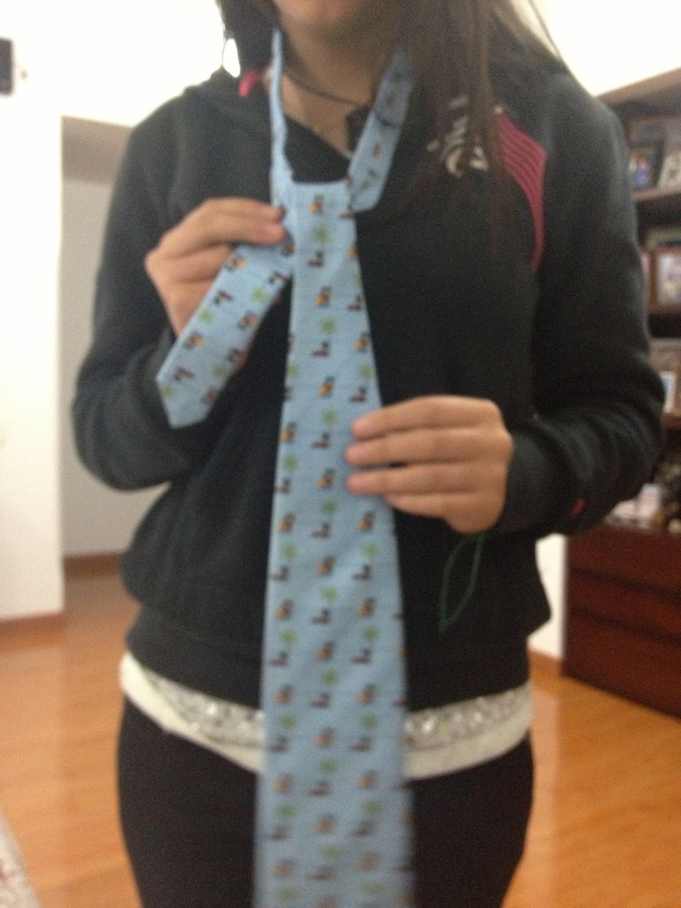 After that you put it through the middle of the two pieces and pass it over the for t