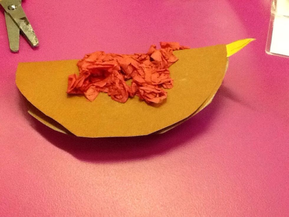 After that, you stick red paper onto the folded circle.