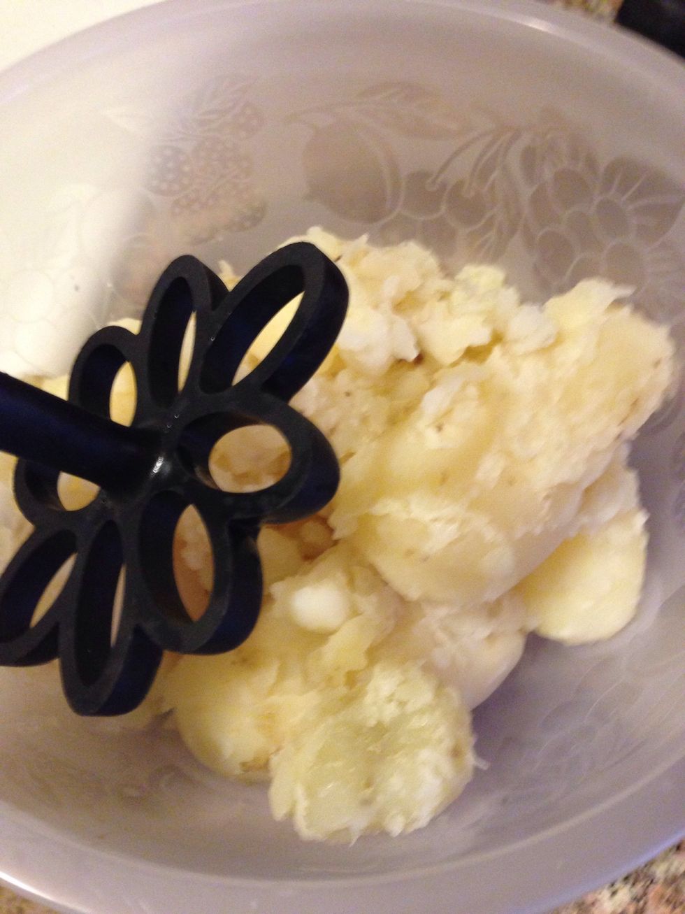 After the 10 minuets of cooling down, the potatoes are ready to be some what mashed. Place the potatoes into the bowl you will be storing the salad in and mash them to your preference.