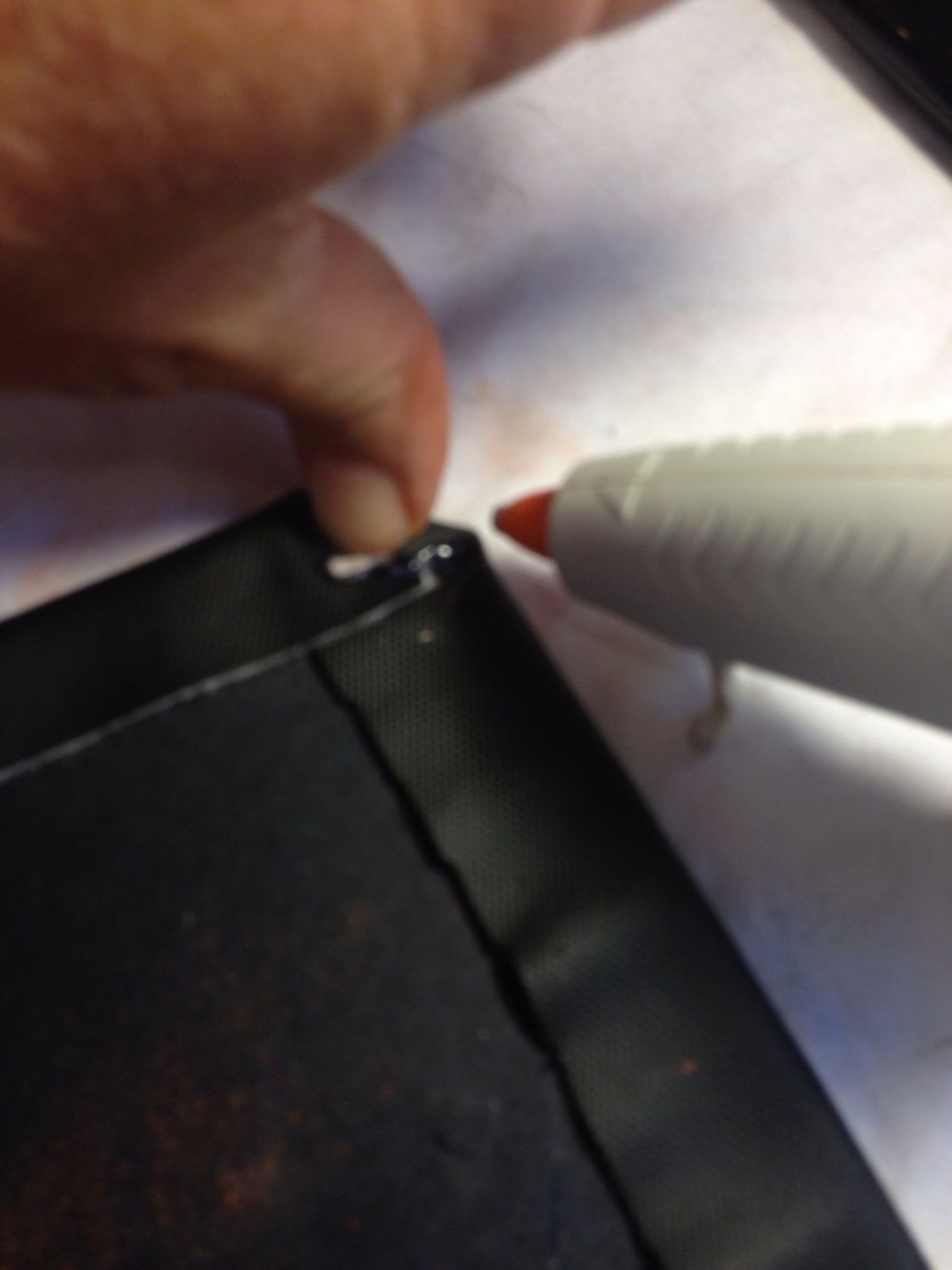 After the adhesive on the board has dried add hot glue gun to fold over the corners. Don't worry this is all on the underside and is not seen.