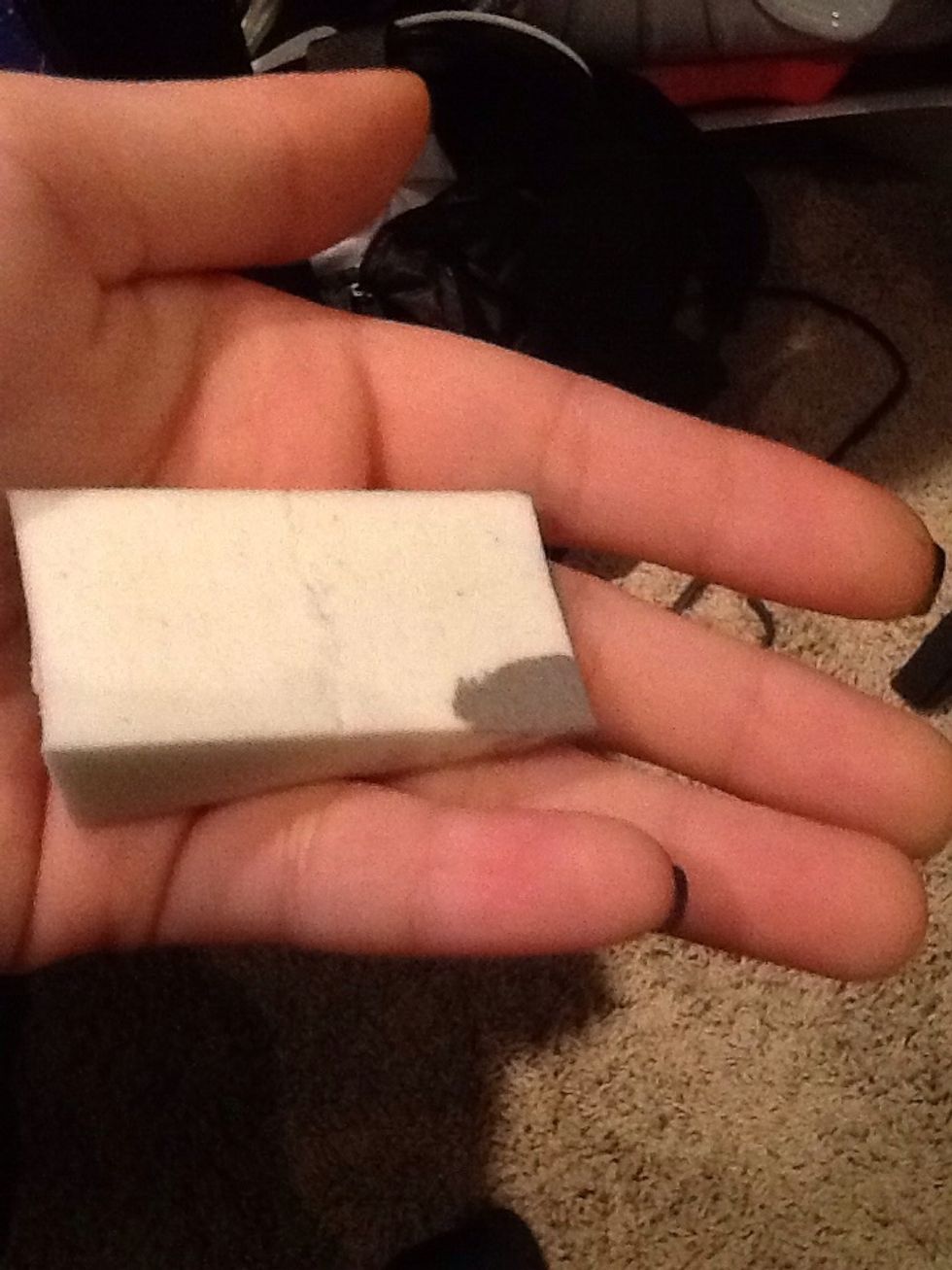 After the black nail polish has dried, take the sponge and put the grey nail polish on it.