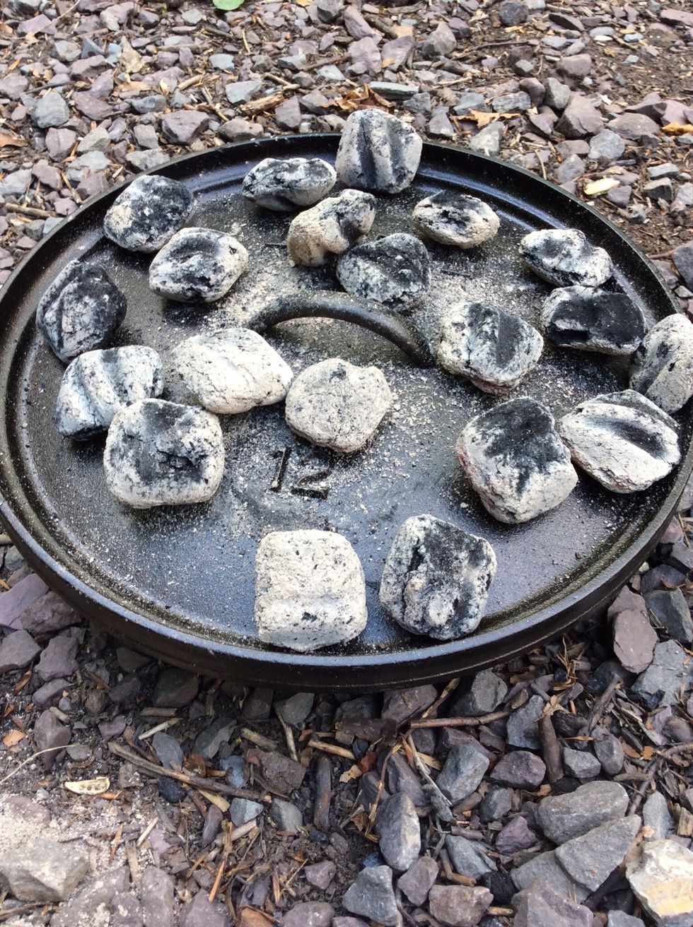After the butter is set aside, I used the lid stand to hold the Dutch oven lid. I have added about 14-16 hot coals to preheat the lid.
