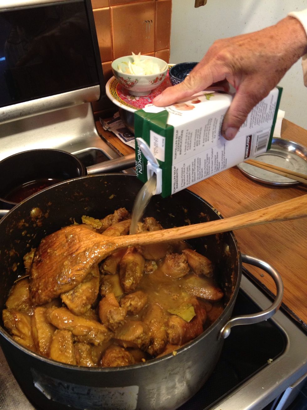 After the chicken has cooked all the way, add a carton of chicken stock. Adding water is fine also.