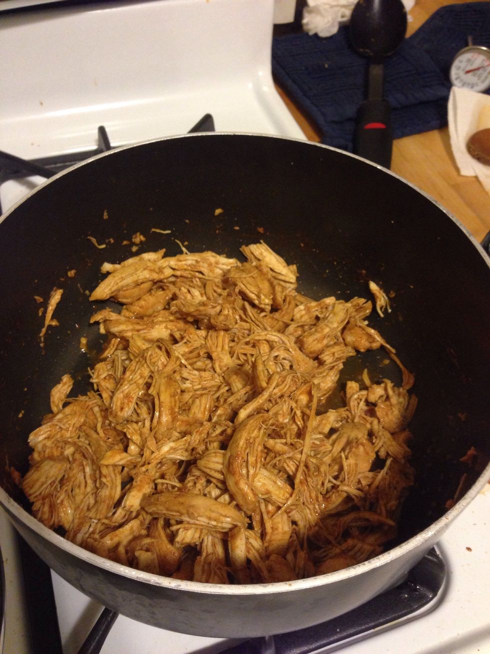 After the chicken is done, shred it. After the chicken finished cooking, there was a bit of broth mixture left over. I shredded with the mixture and it ended up dissolving into the chicken. Yum!