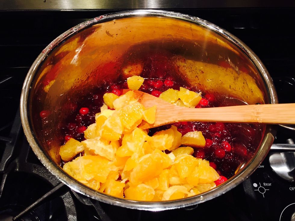 After the cranberries have cooled down, add the fresh sectioned oranges and lightly stir. You'll want the oranges to maintain their shape. (I wonder how yummy this would be for waffles??)
