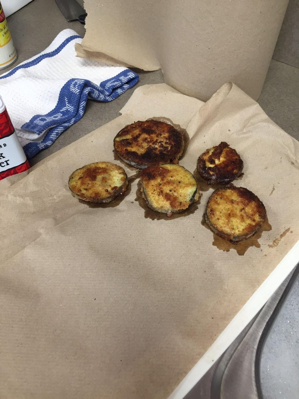 After the eggplant have fried lay them on another pan lined with paper towels