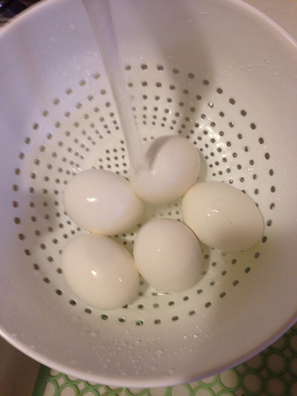 After the eggs are done boiling, be careful and pour the eggs into a strainer. Run cold water over the eggs, until they are cool. (You don't want to burn your finger while peeling the shells off)