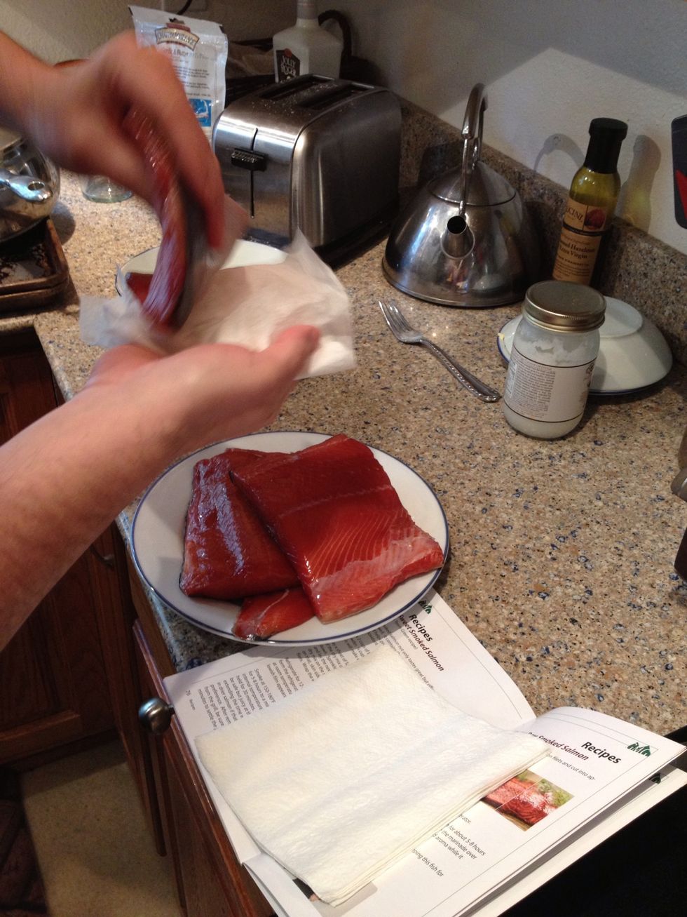 After the filets are rinsed, they need to be patted dry so they aren't drippy when putting on the smoker.