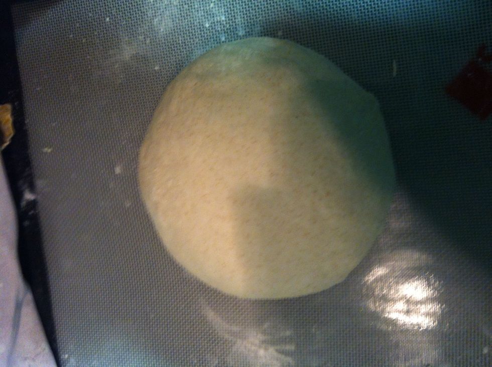 After the final fold, roll the dough over and shape it into a ball