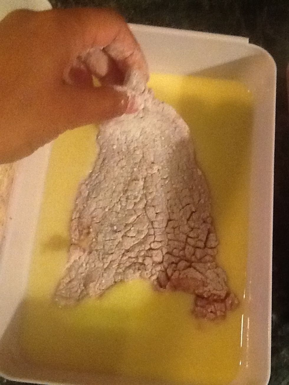 After the flour, dip the beef in the egg.