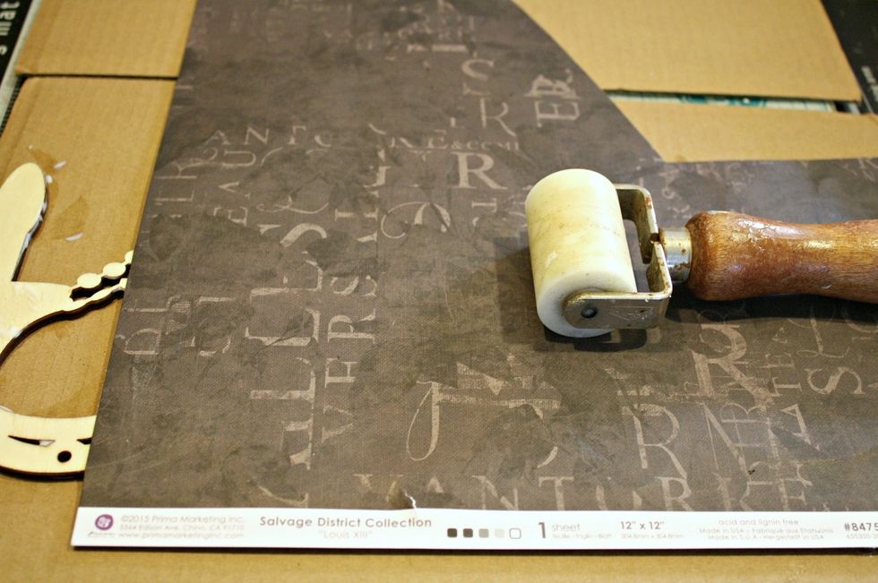 After the gel is added, I adhered my paper, making *SURE* the pattern I want to show is the one being glued down! I use a brayer to make sure that the paper has great contact with the wood.