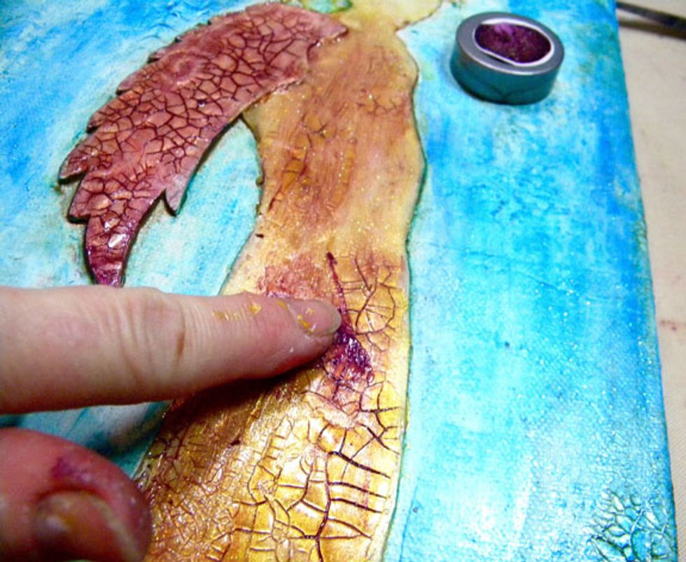 After the glaze is dry, start adding more color to the angel. I chose Imperial Sorbet, applying with my finger, working it into the cracks. Purple is a complimentary color to gold and yellow.
