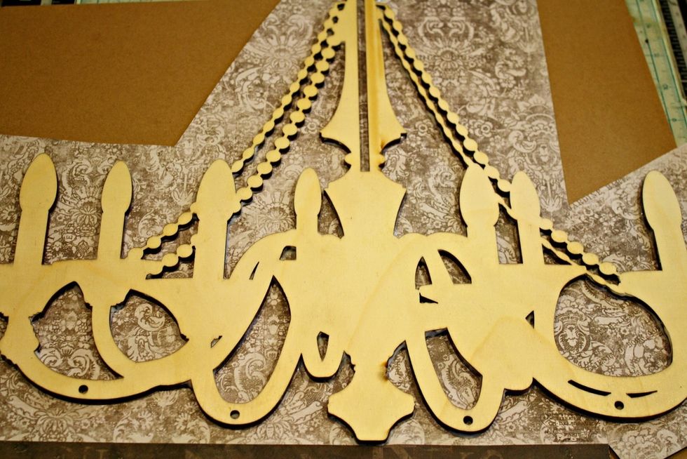 After the glue has dried completely, I trim off the excess paper around my chandelier with scissors. This is just my preference. I like to have as little paper to deal with later on as possible.