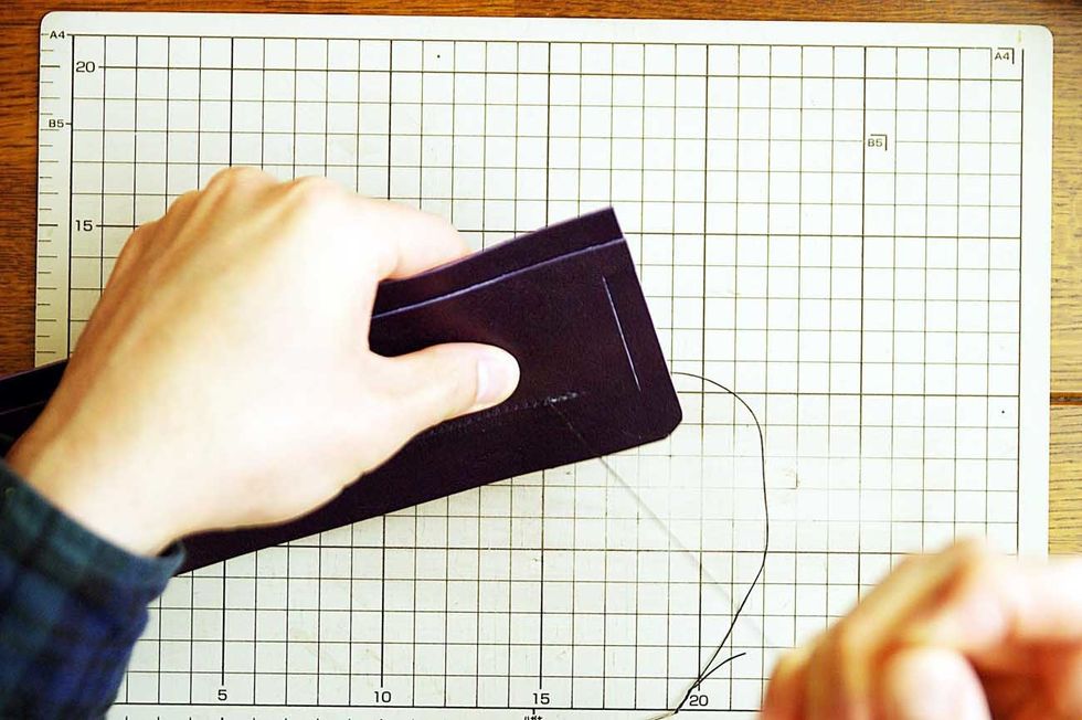 After the glue has dried, sew it with the wax cord.