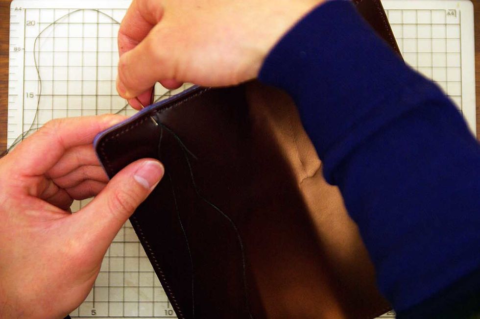 After the glue has dried, sew it with the wax cord.