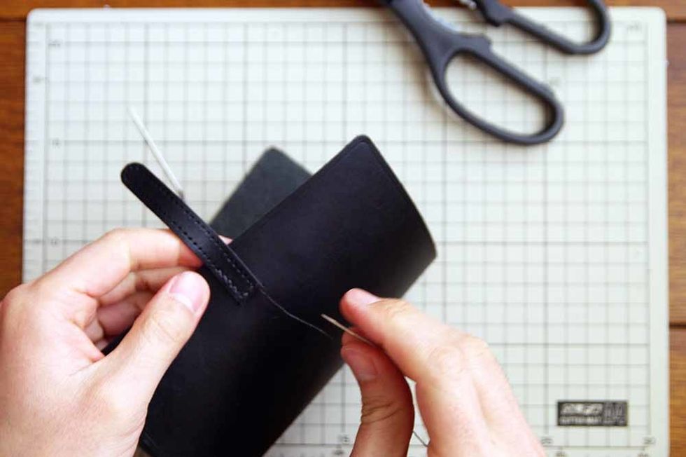 After the glue has dried, sew it with the wax cord.