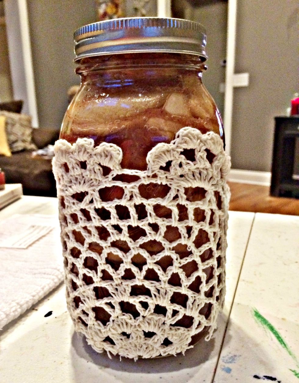After the glue has set, glue the doily to the jar.