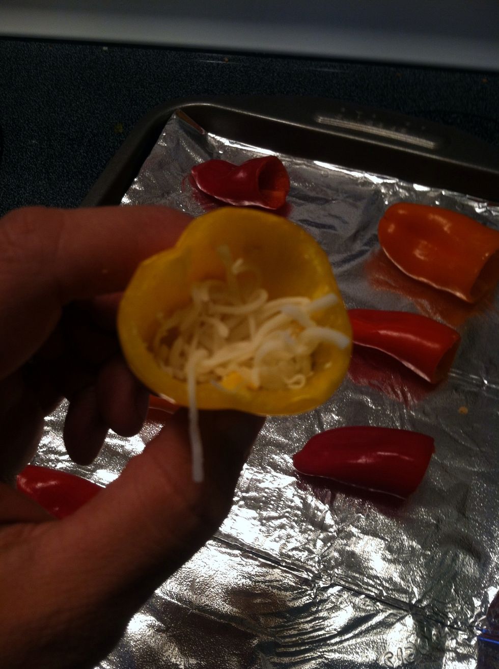 After the meat is fully cooked, stuff your peppers with cheese. This pic needs some light! :-)