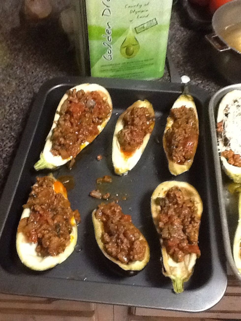 After the meat mixture is browned, prepare to fill the eggplant bowls. If desired, pour some olive oil over the eggplant before adding the meat mixture. (Make sure to coat the pan with evoo)