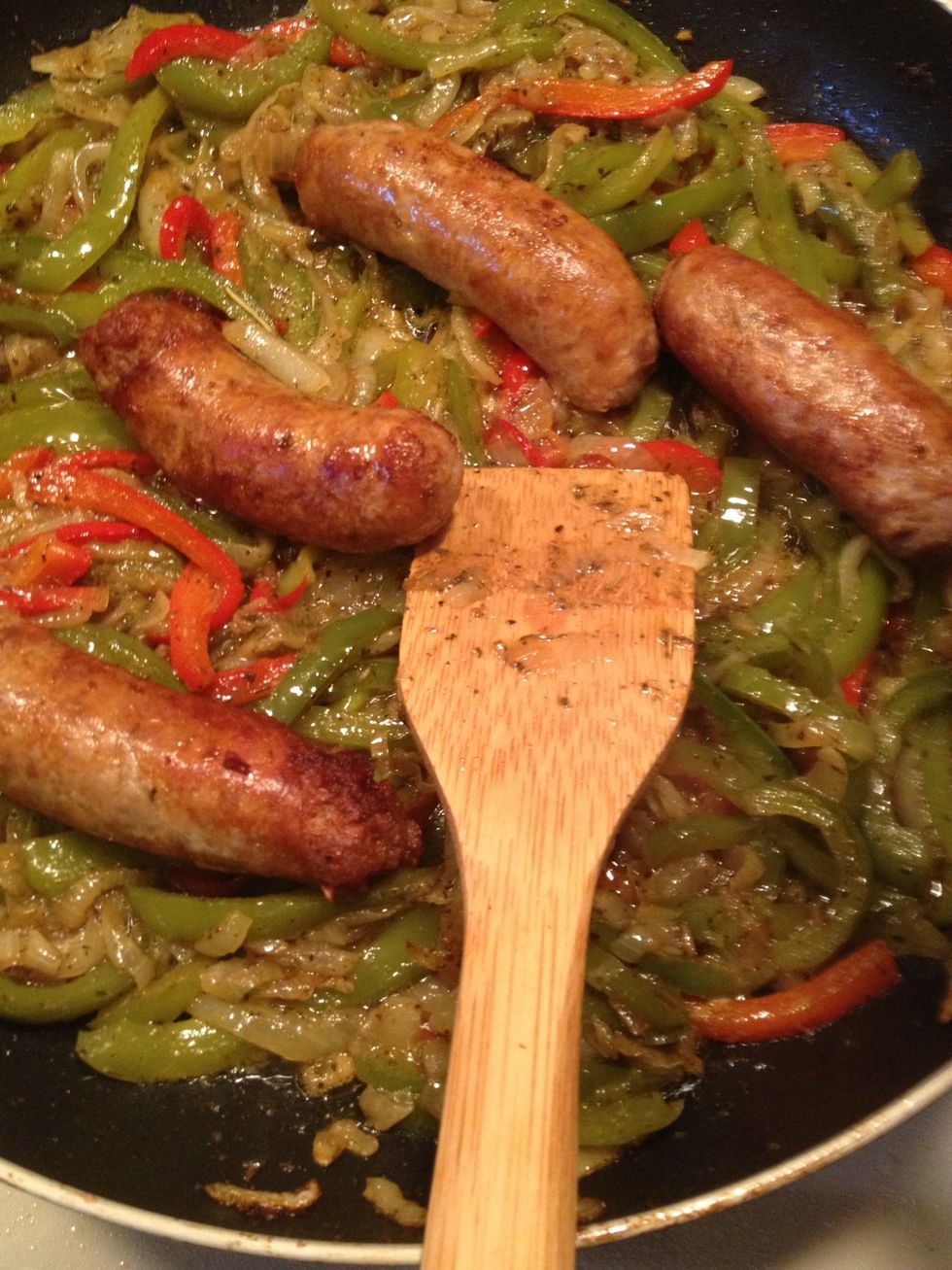 After the onion and peppers are done we will add the sausages back to the pan. Let this cook until the sausages are warmed.