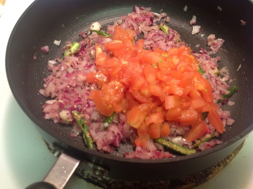 After the onions turn translucent, add in tomatoes and cook till mushy.